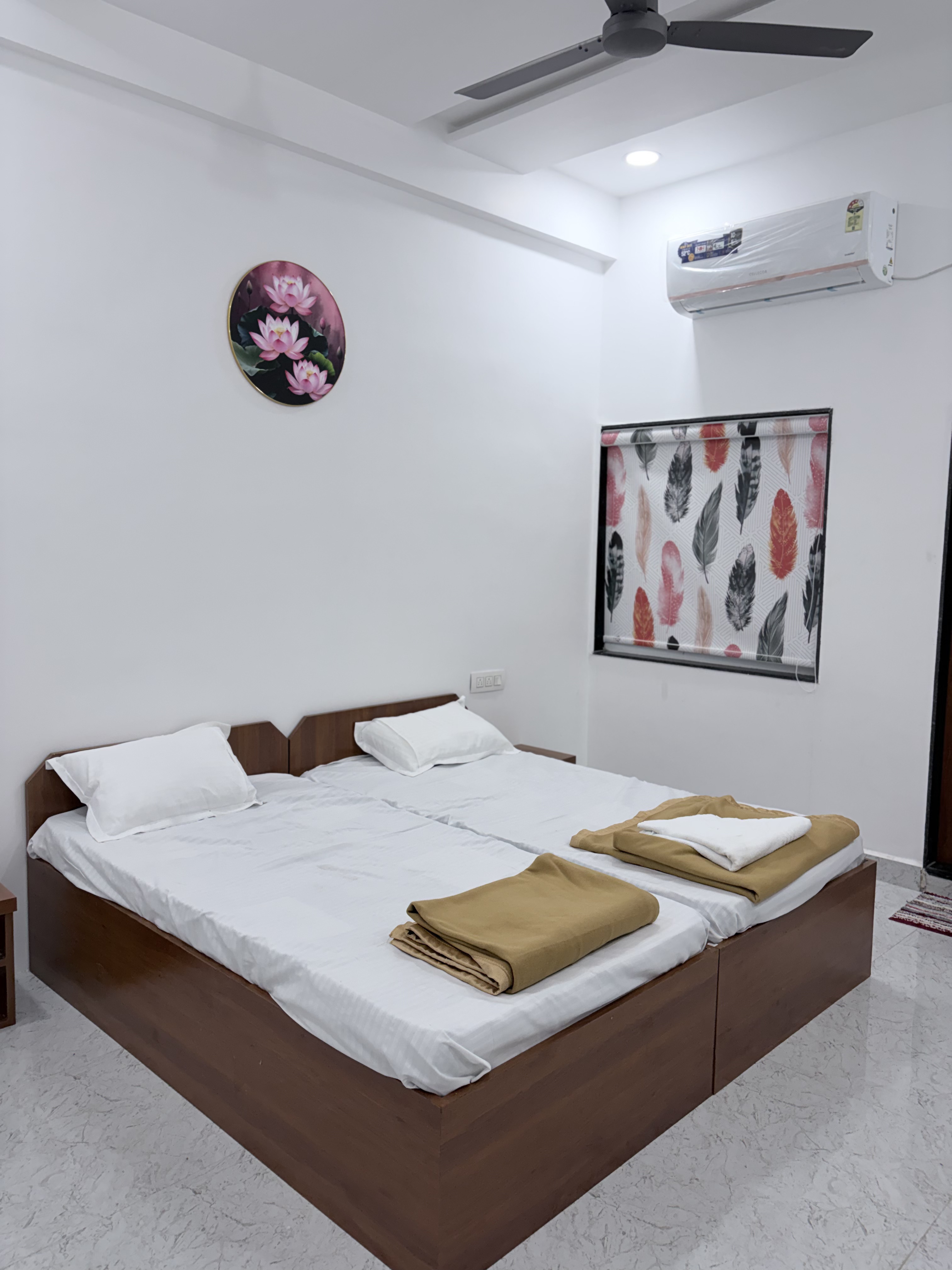 Fresh linen and bedside detail in a room at Keshav Residency